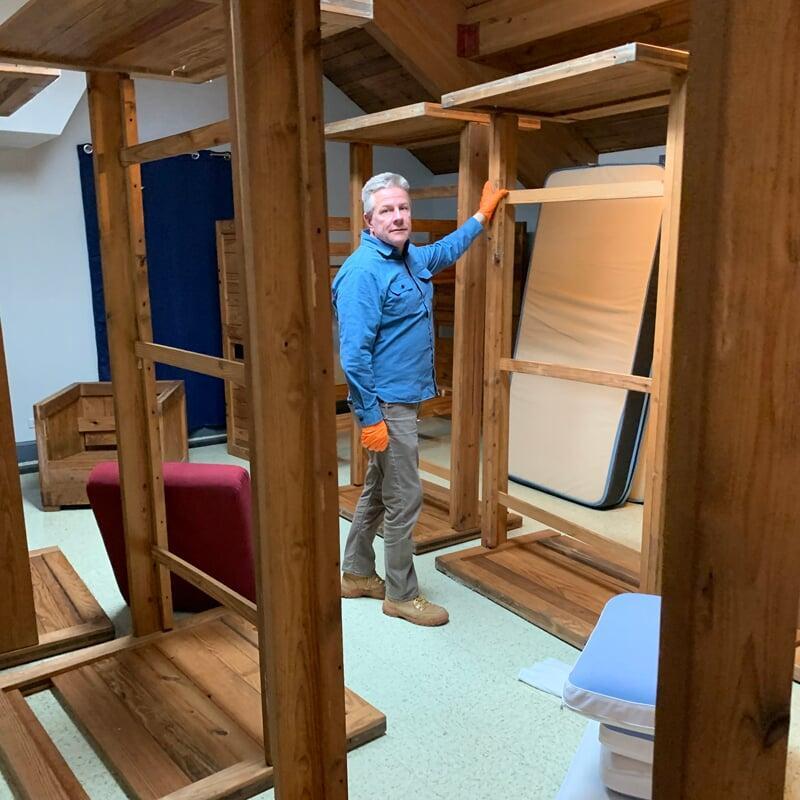 Inspecting bed frames in the sleeping quarters of a local fire station.